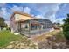 Expansive backyard features a screened-in patio area, offering a perfect space for outdoor relaxation at 148 Miro Dr, Davenport, FL 33837