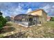 Expansive backyard features a screened-in patio area, offering a perfect space for outdoor relaxation at 148 Miro Dr, Davenport, FL 33837