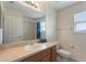 Bathroom featuring a single vanity, toilet, and a shower over bath at 148 Miro Dr, Davenport, FL 33837