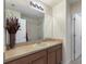 Bathroom featuring a single vanity with a large mirror and a shower over bath at 148 Miro Dr, Davenport, FL 33837