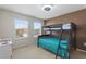 Bedroom with bunk beds, carpeted floor, and two windows for natural light at 148 Miro Dr, Davenport, FL 33837