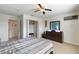 Bedroom with queen-sized bed, dark dresser, ceiling fan, and closet at 148 Miro Dr, Davenport, FL 33837
