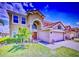 Two-story home with a red tile roof, red front door, and a well-manicured lawn at 148 Miro Dr, Davenport, FL 33837