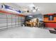 Spacious garage featuring tile flooring, storage, fan, and other appliances and decorations at 148 Miro Dr, Davenport, FL 33837