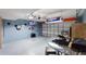 Finished garage is a game room or storage space with blue walls and a drop ceiling at 148 Miro Dr, Davenport, FL 33837