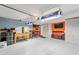 Spacious garage featuring tile flooring, storage, fan, and other appliances and decorations at 148 Miro Dr, Davenport, FL 33837