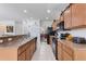 Spacious kitchen with stainless steel appliances, light wood cabinets and a tile backsplash at 148 Miro Dr, Davenport, FL 33837