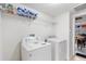 Laundry room with machines, shelving, and access to the garage/game room at 148 Miro Dr, Davenport, FL 33837