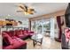 Bright living room featuring comfortable sofa, patio access, and warm ambient lighting at 148 Miro Dr, Davenport, FL 33837