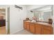 Main bathroom with dual sinks, granite countertops, large mirror, and elegant decor at 148 Miro Dr, Davenport, FL 33837