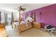 Main bedroom featuring modern four-poster bed, ensuite bathroom, and large windows at 148 Miro Dr, Davenport, FL 33837