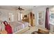 Main bedroom featuring modern four-poster bed, ensuite bathroom, and access to the outside at 148 Miro Dr, Davenport, FL 33837