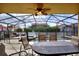 Enclosed pool patio with a large table and chairs, perfect for outdoor living and entertaining at 148 Miro Dr, Davenport, FL 33837