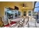 Inviting covered patio featuring an outdoor ceiling fan and ample seating for entertaining guests at 148 Miro Dr, Davenport, FL 33837