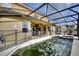 The backyard features a screened in pool area with ample space for seating and relaxation at 148 Miro Dr, Davenport, FL 33837