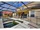 The backyard features a screened in pool area with ample space for seating and relaxation at 148 Miro Dr, Davenport, FL 33837