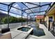 The backyard features a screened in pool area with ample space for seating and relaxation at 148 Miro Dr, Davenport, FL 33837