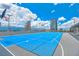 Blue rooftop basketball court with the city skyline and the clouds in the background at 150 E Robinson St # 407, Orlando, FL 32801