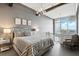 Inviting bedroom showcases modern chandelier lighting, exposed ductwork and a sitting chair at 150 E Robinson St # 407, Orlando, FL 32801