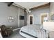 Spacious bedroom with exposed ductwork, wood beams, and a cozy seating area with a closet at 150 E Robinson St # 407, Orlando, FL 32801