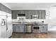 Stylish kitchen featuring stainless appliances, gray cabinets, and tile backsplash at 150 E Robinson St # 407, Orlando, FL 32801