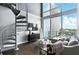 Bright living room with modern spiral staircase and expansive windows offering city views at 150 E Robinson St # 407, Orlando, FL 32801