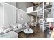 Open-concept living area features a comfortable sofa, spiral staircase, and modern decor at 150 E Robinson St # 407, Orlando, FL 32801