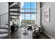 Bright living room featuring large windows and views from adjacent spiral staircase at 150 E Robinson St # 407, Orlando, FL 32801