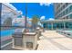 Community outdoor kitchen area with grill and sink, basketball court, and city view at 150 E Robinson St # 407, Orlando, FL 32801