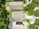 Aerial view showcases the home's layout and landscaping, including a pool and lush surroundings at 1617 Song Sparrow Ct, Sanford, FL 32773