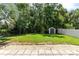 Well-maintained backyard featuring lush greenery, a storage shed, and a partial fence at 1617 Song Sparrow Ct, Sanford, FL 32773