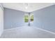 Serene bedroom features two large windows bringing in natural light, with neutral carpet and paint at 1617 Song Sparrow Ct, Sanford, FL 32773