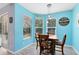 Charming dining area with wood table, pendant lighting, and bright, cheerful blue walls at 1617 Song Sparrow Ct, Sanford, FL 32773