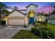Stunning two-story home with a blue front door, lush landscaping, and a two-car garage at 1617 Song Sparrow Ct, Sanford, FL 32773