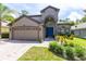 Charming two-story home with a manicured lawn, lovely landscaping, and a two-car garage at 1617 Song Sparrow Ct, Sanford, FL 32773