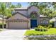 Inviting two-story home with a manicured lawn, mature landscaping, and a two-car garage at 1617 Song Sparrow Ct, Sanford, FL 32773