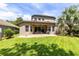 Rear exterior view of a well-maintained home with a patio and lush lawn at 1617 Song Sparrow Ct, Sanford, FL 32773