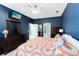 Comfortable main bedroom showcasing a large dresser, TV, and access to ensuite bathroom at 1617 Song Sparrow Ct, Sanford, FL 32773