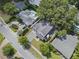 Bird's-eye view of a home with a dark roof, lush landscaping, and neighboring houses, showcasing the property's setting at 1780 Mizell Ave., Winter Park, FL 32789