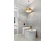 Modern bathroom with soaking tub, light wood bath caddy, stylish light fixture, and elegant tile work at 1780 Mizell Ave., Winter Park, FL 32789