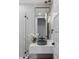 Elegant bathroom featuring modern fixtures, chic lighting, and a decorative mirror at 1780 Mizell Ave., Winter Park, FL 32789