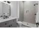 Modern bathroom featuring a vanity, toilet, and tiled shower with a built-in niche for storage at 1780 Mizell Ave., Winter Park, FL 32789