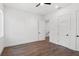 Minimalist bedroom with wood floors, white walls, fan, and multiple doors at 1780 Mizell Ave., Winter Park, FL 32789