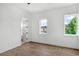 Bright bedroom with two windows, wood-look flooring, and white walls at 1780 Mizell Ave., Winter Park, FL 32789