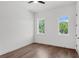 Bright bedroom with hardwood floors, white walls, and windows overlooking the trees at 1780 Mizell Ave., Winter Park, FL 32789