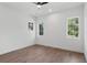 Bright bedroom with wood floors, white walls, three windows and a ceiling fan at 1780 Mizell Ave., Winter Park, FL 32789