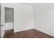 Wood-floored bedroom with a light wall color, white trim, and a partially visible closet at 1780 Mizell Ave., Winter Park, FL 32789