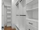 Spacious walk-in closet with custom white shelving, hanging rods, and drawers for ample storage at 1780 Mizell Ave., Winter Park, FL 32789