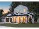 Elegant two-story home featuring a three-car garage and a welcoming front porch with decorative lighting at 1780 Mizell Ave., Winter Park, FL 32789