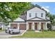 Elegant two-story home featuring a three-car garage, with modern design and a luxury sports car at 1780 Mizell Ave., Winter Park, FL 32789